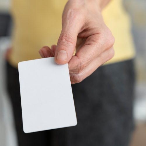 hand-holding-blank-business-card-high-angle_23-2149343416